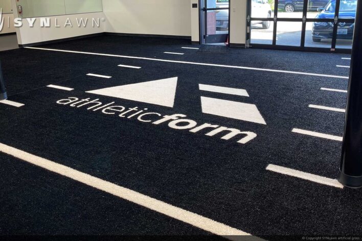 SYNLawn Bermuda prefab turf logos for athletic weight room applications